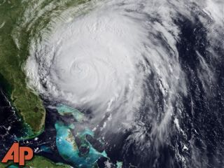 This satellite image provided by NOAA and taken at 12:45 GMT Friday Aug. 26, 2011 shows Hurricane Irene as it moves northward along the U.S. eastern coastline with 110 mph sustained winds. (AP Photo/NOAA)
