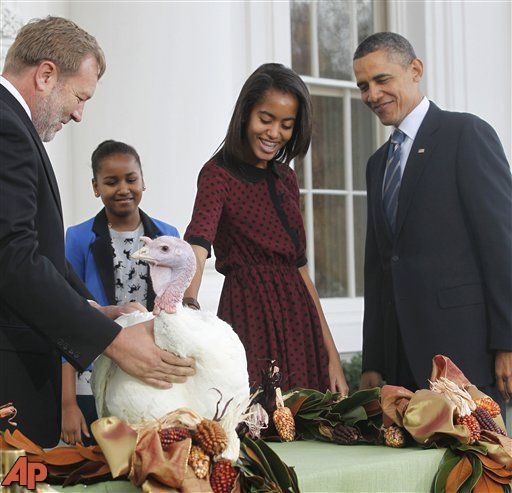 President Barack Obama, with daughters Sasha and Malia, pardons Liberty, a 19-week old, 45-pound turkey, on the occasion of Thanksgiving, Wednesday. (AP Photo/Pablo Martinez Monsivais)
