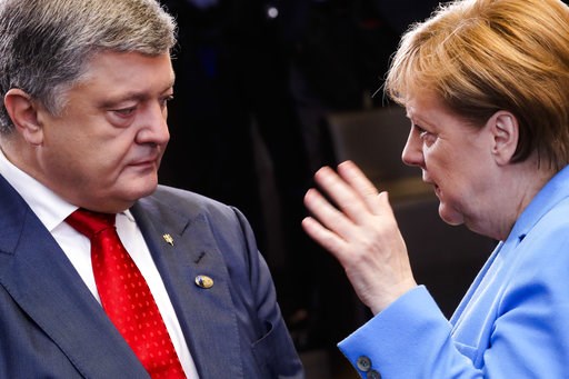 (AP Photo/Markus Schreiber). German Chancellor Angela Merkel, right, and Ukraine's President Petro Poroshenko, left, talk together, prior to a working session during a summit of heads of state and government at NATO headquarters in Brussels on Wednesda... (AP Photo/Markus Schreiber). German Chancellor Angela Merkel, right, and Ukraine's President Petro Poroshenko, left, talk together, prior to a working session during a summit of heads of state and government at NATO headquarters in Brussels on Wednesda...