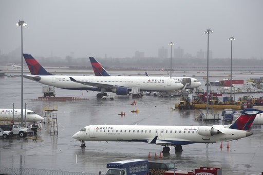 (AP Photo/Mark Lennihan, File). FILE- In this March 2, 2018, file photo, Delta Air Lines planes are grounded in New York. Delta Air Lines reports earns on Thursday, July 12. (AP Photo/Mark Lennihan, File). FILE- In this March 2, 2018, file photo, Delta Air Lines planes are grounded in New York. Delta Air Lines reports earns on Thursday, July 12.