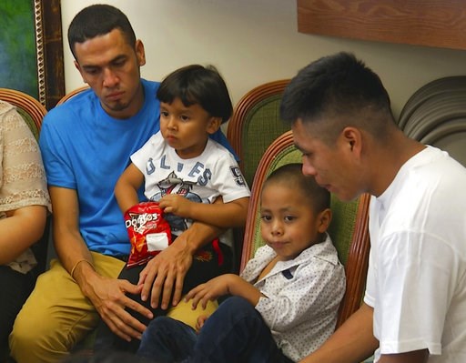 (AP Photo/Robert Bumsted). In this image taken from video, Javier Garrido Martinez, left and Alan Garcia, right, sit with their 4-year-sons at a news conference in New York, Wednesday, July 11, 2018. They men were reunited with their children after alm... (AP Photo/Robert Bumsted). In this image taken from video, Javier Garrido Martinez, left and Alan Garcia, right, sit with their 4-year-sons at a news conference in New York, Wednesday, July 11, 2018. They men were reunited with their children after alm...