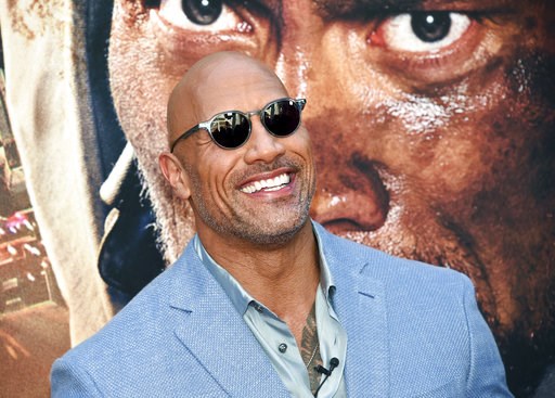 (Photo by Evan Agostini/Invision/AP, File). FILE - In this July 10, 2018 file photo, Actor Dwayne Johnson attends the "Skyscraper" premiere in New York. Johnson, who plays an amputee in the action movie, said Thursday, July 12, he is joining the Boston... (Photo by Evan Agostini/Invision/AP, File). FILE - In this July 10, 2018 file photo, Actor Dwayne Johnson attends the "Skyscraper" premiere in New York. Johnson, who plays an amputee in the action movie, said Thursday, July 12, he is joining the Boston...