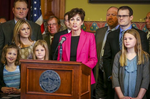 (Rodney White/The Des Moines Register via AP). In this April 2, 2018 photo, Gov. Kim Reynolds prepares to sign a bill allowing unregulated health plans at the Iowa Statehouse in Des Moines, Iowa. The Iowa law approved this spring in the Republican-cont... (Rodney White/The Des Moines Register via AP). In this April 2, 2018 photo, Gov. Kim Reynolds prepares to sign a bill allowing unregulated health plans at the Iowa Statehouse in Des Moines, Iowa. The Iowa law approved this spring in the Republican-cont...