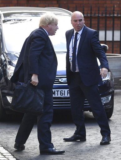 (Victoria Jones/PA via AP). British member of parliament Boris Johnson, left, arrives at Westminster in London, Tuesday July 10, 2018. Johnson resigned from his Government Cabinet position on Monday. (Victoria Jones/PA via AP). British member of parliament Boris Johnson, left, arrives at Westminster in London, Tuesday July 10, 2018. Johnson resigned from his Government Cabinet position on Monday.