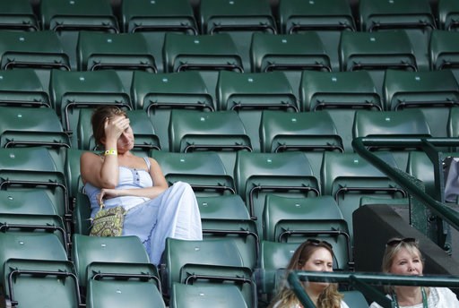 (AP Photo/Ben Curtis). Spectators attend the men's singles quarterfinal tennis match between John Isner of the United States and Canada's Milos Raonic, at the Wimbledon Tennis Championships, in London, Wednesday July 11, 2018. (AP Photo/Ben Curtis). Spectators attend the men's singles quarterfinal tennis match between John Isner of the United States and Canada's Milos Raonic, at the Wimbledon Tennis Championships, in London, Wednesday July 11, 2018.