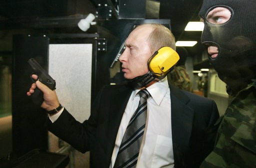 (Dmitry Astakhov, Sputnik, Kremlin Pool Photo via AP). FILE In this file photo taken on Wednesday, Nov. 8, 2006, President Vladimir Putin wears headphones as he tests a pistol in a shooting range as he visits the Defense Ministry's Main Intelligence Di... (Dmitry Astakhov, Sputnik, Kremlin Pool Photo via AP). FILE In this file photo taken on Wednesday, Nov. 8, 2006, President Vladimir Putin wears headphones as he tests a pistol in a shooting range as he visits the Defense Ministry's Main Intelligence Di...