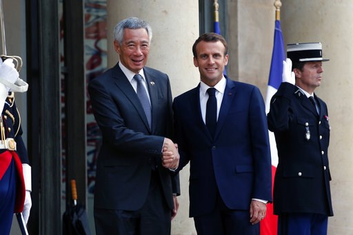(AP Photo/Thibault Camus). France's President Emmanuel Macron, right, shakes hand with Singapore Prime Minister Lee Hsien Loong, prior to a State dinner, at the Elysee Palace, in Paris, Friday, July 13, 2018. (AP Photo/Thibault Camus). France's President Emmanuel Macron, right, shakes hand with Singapore Prime Minister Lee Hsien Loong, prior to a State dinner, at the Elysee Palace, in Paris, Friday, July 13, 2018.