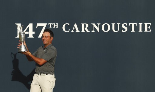 Molinari survives wild day to win British Open