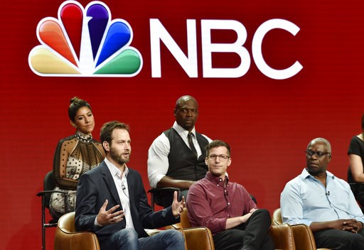 (Photo by Chris Pizzello/Invision/AP). Dan Goor, bottom left, executive producer of the NBC Universal television series "Brooklyn Nine-Nine," answers a question as cast members, from left, Stephanie Beatriz, Terry Crews, Andy Samberg and Andre Braugher... (Photo by Chris Pizzello/Invision/AP). Dan Goor, bottom left, executive producer of the NBC Universal television series "Brooklyn Nine-Nine," answers a question as cast members, from left, Stephanie Beatriz, Terry Crews, Andy Samberg and Andre Braugher...