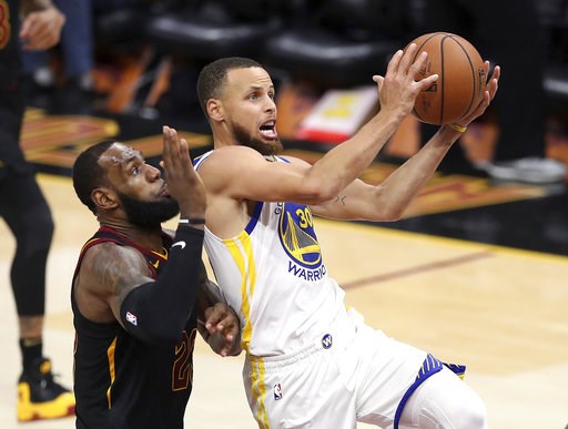 (AP Photo/Carlos Osorio, File). FILE - In this June 6, 2018 file photo, Golden State Warriors' Stephen Curry goes to the basket against Cleveland Cavaliers' LeBron James, left, during the second half of Game 3 of basketball's NBA Finals in Cleveland. C... (AP Photo/Carlos Osorio, File). FILE - In this June 6, 2018 file photo, Golden State Warriors' Stephen Curry goes to the basket against Cleveland Cavaliers' LeBron James, left, during the second half of Game 3 of basketball's NBA Finals in Cleveland. C...