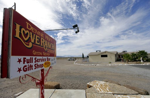 (AP Photo/Chris Carlson, File). FILE - In this Oct. 14, 2015, file photo, a sign advertises Dennis Hof's Love Ranch brothel in Crystal, Nev. County officials in Nevada have yanked a brothel license from the state's most famous pimp who has fashioned hi... (AP Photo/Chris Carlson, File). FILE - In this Oct. 14, 2015, file photo, a sign advertises Dennis Hof's Love Ranch brothel in Crystal, Nev. County officials in Nevada have yanked a brothel license from the state's most famous pimp who has fashioned hi...