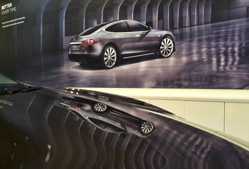 (AP Photo/Richard Vogel). An image of a Tesla model X is seen reflected on the hood of a new model 3 in the Tesla showroom in Santa Monica, Calif., on Wednesday, Aug. 8, 2018. Board members at Tesla are evaluating CEO and Chairman Elon Musk's $72 billi... (AP Photo/Richard Vogel). An image of a Tesla model X is seen reflected on the hood of a new model 3 in the Tesla showroom in Santa Monica, Calif., on Wednesday, Aug. 8, 2018. Board members at Tesla are evaluating CEO and Chairman Elon Musk's $72 billi...