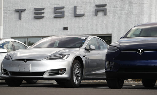 (AP Photo/David Zalubowski). In this July 8, 2018, photo, 2018 Model 3 sedan sits next to a Model X on display outside a Tesla showroom in Littleton, Colo. Board members at Tesla are evaluating CEO and Chairman Elon Musk’s $72 billion proposal to take ... (AP Photo/David Zalubowski). In this July 8, 2018, photo, 2018 Model 3 sedan sits next to a Model X on display outside a Tesla showroom in Littleton, Colo. Board members at Tesla are evaluating CEO and Chairman Elon Musk’s $72 billion proposal to take ...