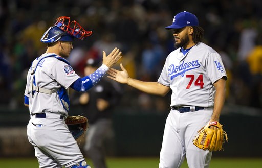 (AP Photo/D. Ross Cameron). Los Angeles Dodgers catcher Yasmani Grandal (9) and pitcher Kenley Jansen (74) celebrate the team's 4-2 victory over the Oakland Athletics in a baseball game, Tuesday, Aug. 7, 2018, in Oakland, Calif. (AP Photo/D. Ross Cameron). Los Angeles Dodgers catcher Yasmani Grandal (9) and pitcher Kenley Jansen (74) celebrate the team's 4-2 victory over the Oakland Athletics in a baseball game, Tuesday, Aug. 7, 2018, in Oakland, Calif.
