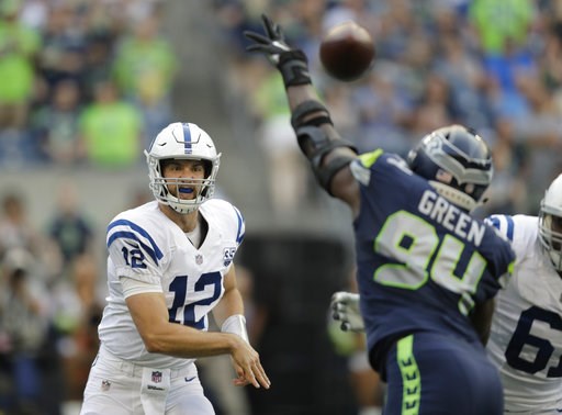 (AP Photo/Stephen Brashear). Indianapolis Colts quarterback Andrew Luck (12) passes through the defense of Seattle Seahawks defensive end Rasheem Green during the first half of an NFL football preseason game, Thursday, Aug. 9, 2018, in Seattle. (AP Photo/Stephen Brashear). Indianapolis Colts quarterback Andrew Luck (12) passes through the defense of Seattle Seahawks defensive end Rasheem Green during the first half of an NFL football preseason game, Thursday, Aug. 9, 2018, in Seattle.