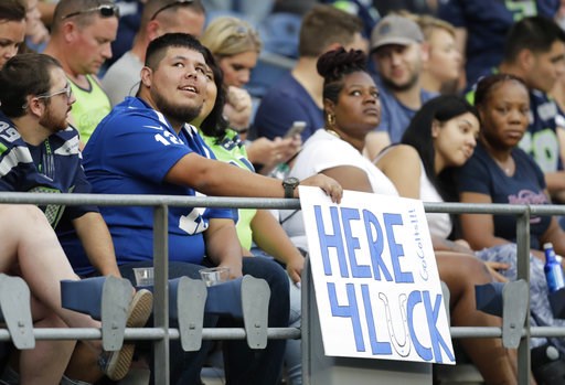 (AP Photo/Stephen Brashear). A fan holds a sign that reads "Here 4 Luck" in support of Indianapolis Colts quarterback Andrew Luck during the first half of an NFL football preseason game against the Seattle Seahawks, Thursday, Aug. 9, 2018, in Seattle. (AP Photo/Stephen Brashear). A fan holds a sign that reads "Here 4 Luck" in support of Indianapolis Colts quarterback Andrew Luck during the first half of an NFL football preseason game against the Seattle Seahawks, Thursday, Aug. 9, 2018, in Seattle.