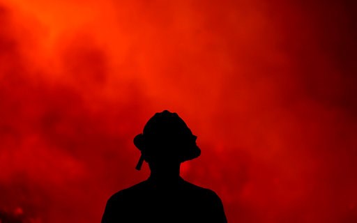 (AP Photo/Ringo H.W. Chiu). A firefighter keeps watch on the Holy Fire burning in the Cleveland National Forest in Lake Elsinore, Calif., Thursday, Aug. 9, 2018. (AP Photo/Ringo H.W. Chiu). A firefighter keeps watch on the Holy Fire burning in the Cleveland National Forest in Lake Elsinore, Calif., Thursday, Aug. 9, 2018.