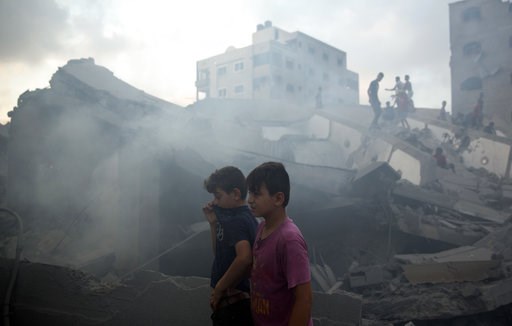(AP Photo/Khalil Hamra). Palestinians inspect the damaged building of Said al-Mis'hal cultural center after it was hit bombed by an Israeli airstrike in Gaza City, Thursday, Aug. 9, 2018. The Palestinian Health Ministry says several bystanders were wo... (AP Photo/Khalil Hamra). Palestinians inspect the damaged building of Said al-Mis'hal cultural center after it was hit bombed by an Israeli airstrike in Gaza City, Thursday, Aug. 9, 2018. The Palestinian Health Ministry says several bystanders were wo...