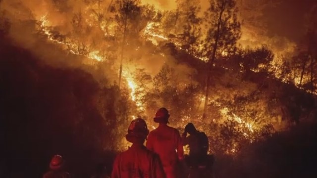 Flames inch close to California homes as thousands evacuate