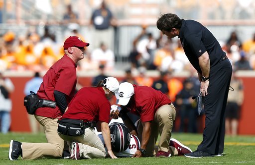 (AP Photo/Wade Payne, File). FILE - In this Oct. 14, 2017, file photo, South Carolina head coach Will Muschamp, right, checks on running back Rico Dowdle (5) after he was injured in the first half of an NCAA college football game against Tennessee in K... (AP Photo/Wade Payne, File). FILE - In this Oct. 14, 2017, file photo, South Carolina head coach Will Muschamp, right, checks on running back Rico Dowdle (5) after he was injured in the first half of an NCAA college football game against Tennessee in K...