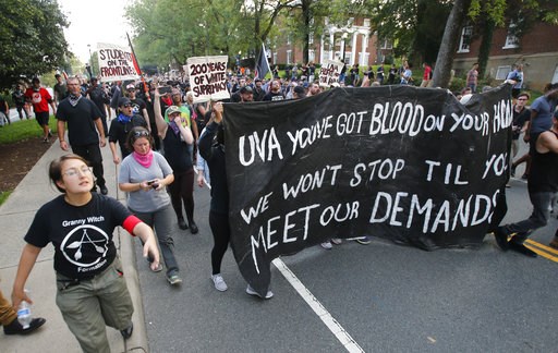 (AP Photo/Steve Helber). A group of anti-fascist and Black Lives Matter demonstrators march on the campus of the University of Virginia after a rally to mark the anniversary of last year's Unite the Right rally in Charlottesville, Va., Saturday, Aug. 1... (AP Photo/Steve Helber). A group of anti-fascist and Black Lives Matter demonstrators march on the campus of the University of Virginia after a rally to mark the anniversary of last year's Unite the Right rally in Charlottesville, Va., Saturday, Aug. 1...
