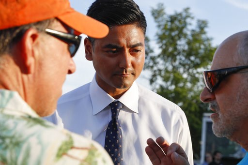 (AP Photo/John Minchillo). Hamilton County Clerk of Courts Aftab Pureval speaks with constituents as he campaigns for his 1st House District challenge against veteran Republican Rep. Steve Chabot at a music festival, Friday, June 15, 2018, in Mason, Oh... (AP Photo/John Minchillo). Hamilton County Clerk of Courts Aftab Pureval speaks with constituents as he campaigns for his 1st House District challenge against veteran Republican Rep. Steve Chabot at a music festival, Friday, June 15, 2018, in Mason, Oh...