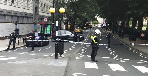 The Latest: UK police say properties raided after car crash