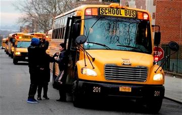  line up to drop off students in New York, Tuesday, Jan. 15, 2013