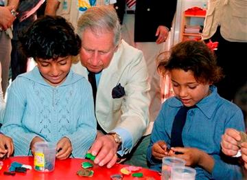 (AP Photo/Jamal Nasrallah, Pool). Britain's Prince Charles, center, sits with Syrian refugee children during his visit to the King Abdullah Park for Syrian Refugees in Ramtha city north of Amman, Jordan, Wednesday, March 13, 2013.