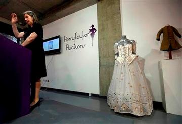 (AP Photo/Lefteris Pitarakis). A 1986 Emanuel ball gown worn by late Princess Diana is displayed on a mannequin during an auction in London, Tuesday, Dec. 3, 2013.