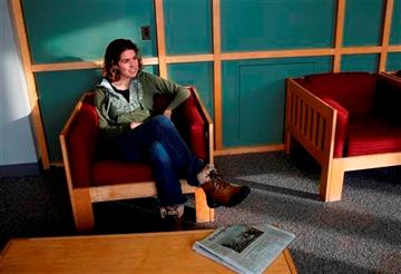 (AP Photo/Elise Amendola). Freshman Lydia Collins, 19, chats with a friend in a lounge at Tufts University in Medford, Mass., Thursday, March 13, 2014.