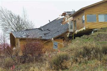 (AP Photo/Jackson Hole News and Guide, Angus M. Thuermer Jr). A house breaks apart as a slow-moving landslide in Jackson, Wyo. advances downhill on Friday, April 18. 2014.