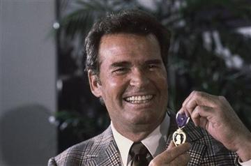 (AP Photo/Lennox McLendon, File). FILE - Actor James Garner, left, smiles as he holds up the Purple Heart medal presented to him in a ceremony in this Monday, Jan. 24, 1983 file photo taken Los Angeles, Calif.