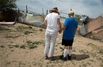 (AP Photo/Albuquerque Journal, Roberto E. Rosales). Concerned citizens observe a moment of silence, Monday, July 21, 2014 in the field where two homeless men were bludgeoned to death by teenagers over the weekend near in Albuquerque, N.M.