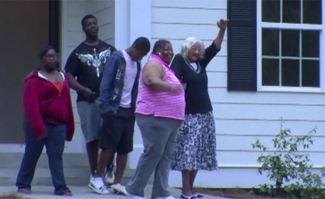Rosa Lee Ransby, right, waved to the media, flanked by her grandchildren, in front of her new house. (Source: CNN)