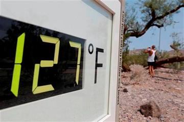 (AP Photo/Chris Carlson). A visitor to the Furnace Creek Vistitor Center walks by a digital thermometer in Death Vally National Park Friday, June 28, 2013 in Furnace Creek, Calif.