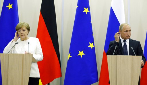 Putin dances at Austrian wedding; talks with Merkel on Syria