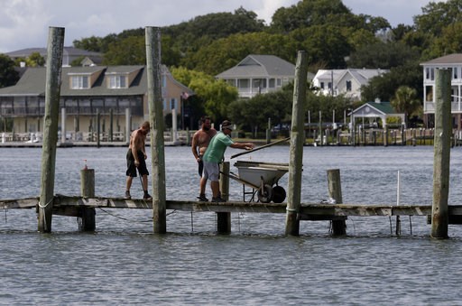 (AP Photo/Tom Copeland). From left, Josh Clappsy, Blake Price, and JB Phillips remove boards from a dock in hopes to save it from rising waters in Swansboro, N.C., Tuesday, Sept. 11, 2018. Florence exploded into a potentially catastrophic hurricane Mon... (AP Photo/Tom Copeland). From left, Josh Clappsy, Blake Price, and JB Phillips remove boards from a dock in hopes to save it from rising waters in Swansboro, N.C., Tuesday, Sept. 11, 2018. Florence exploded into a potentially catastrophic hurricane Mon...