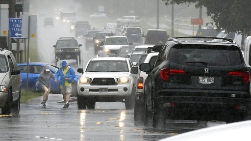 (Matthew Thayer/The News via AP). A couple walks in a rainstorm amid heavy traffic in Paia, Hawaii, on Tuesday, Sept. 11, 2018, as Tropical Storm Olivia marched closer to Maui. Olivia was expected to pass directly over Maui on Tuesday night into Wednes... (Matthew Thayer/The News via AP). A couple walks in a rainstorm amid heavy traffic in Paia, Hawaii, on Tuesday, Sept. 11, 2018, as Tropical Storm Olivia marched closer to Maui. Olivia was expected to pass directly over Maui on Tuesday night into Wednes...