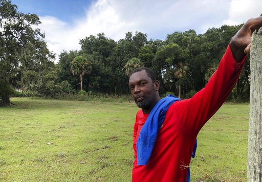 (AP Photo/Russ Bynum). In this Sept. 11, 2018 photo, John Brown stands behind a fence for his cows outside his home on St. Helena Island, S.C. Brown and other residents of the island's Gullah community of slave descendants are watching Hurricane Floren... (AP Photo/Russ Bynum). In this Sept. 11, 2018 photo, John Brown stands behind a fence for his cows outside his home on St. Helena Island, S.C. Brown and other residents of the island's Gullah community of slave descendants are watching Hurricane Floren...