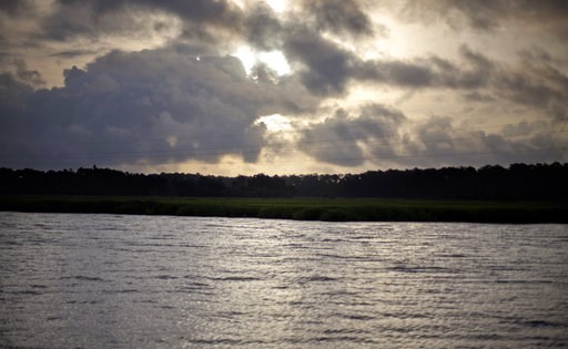 (AP Photo/David Goldman, File). FILE - In this June 10, 2013, file photo, the sun rises over Sapelo Island, Ga., a Gullah-Geechee community. A tight-knit community of slave descendants on the South Carolina coast is used to riding out big storms, from ... (AP Photo/David Goldman, File). FILE - In this June 10, 2013, file photo, the sun rises over Sapelo Island, Ga., a Gullah-Geechee community. A tight-knit community of slave descendants on the South Carolina coast is used to riding out big storms, from ...