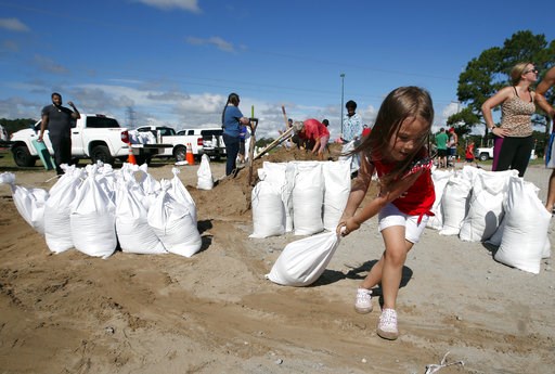 (AP Photo/Alex Brandon). Chloe Heeden, 4, from Virginia Beach, Va., drags a sandbag to her father's car, Wednesday, Sept. 12, 2018, in Virginia Beach, Va., as Hurricane Florence moves towards the eastern shore. The National Hurricane Center's projected... (AP Photo/Alex Brandon). Chloe Heeden, 4, from Virginia Beach, Va., drags a sandbag to her father's car, Wednesday, Sept. 12, 2018, in Virginia Beach, Va., as Hurricane Florence moves towards the eastern shore. The National Hurricane Center's projected...