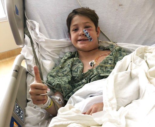 (Shannon Miller via AP). In this Monday, Sept. 10, 2018 photo provided by Shannon Miller, his son Xavier Cunningham, of Harrisonville, Mo., gives a thumbs up while recovering at the University of Kansas Hospital in Kansas City, Kan., after surgery to r... (Shannon Miller via AP). In this Monday, Sept. 10, 2018 photo provided by Shannon Miller, his son Xavier Cunningham, of Harrisonville, Mo., gives a thumbs up while recovering at the University of Kansas Hospital in Kansas City, Kan., after surgery to r...