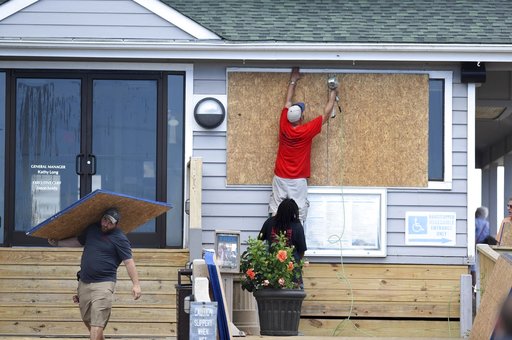 (Matt Born/The Star-News via AP, File). FILE- In this Tuesday, Sept. 11, 2018, photo crews board up the Oceanic restaurant in Wrightsville Beach, N.C., in preparation for Hurricane Florence. Though it’s far from clear how much economic havoc Hurricane ... (Matt Born/The Star-News via AP, File). FILE- In this Tuesday, Sept. 11, 2018, photo crews board up the Oceanic restaurant in Wrightsville Beach, N.C., in preparation for Hurricane Florence. Though it’s far from clear how much economic havoc Hurricane ...