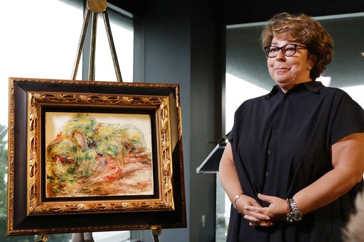 (AP Photo/Mark Lennihan). Sylvie Sulitzer, a delicatessen owner from the south of France, stands with a Renoir painting that was returned to her in a reparation ceremony at a news conference, Wednesday, Sept. 12, 2018, in New York. The 1919 oil paintin... (AP Photo/Mark Lennihan). Sylvie Sulitzer, a delicatessen owner from the south of France, stands with a Renoir painting that was returned to her in a reparation ceremony at a news conference, Wednesday, Sept. 12, 2018, in New York. The 1919 oil paintin...