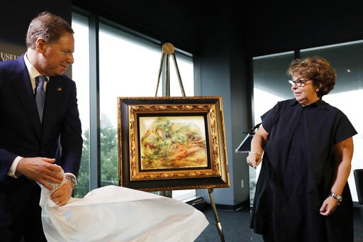 (AP Photo/Mark Lennihan). United States Attorney Geoffrey Berman, left, unveils a Renoir painting with Sylvie Sulitzer at a news conference, Wednesday, Sept. 12, 2018, in New York. The 1919 oil painting "Femmes Dans Un Jardin" was seized in Paris by th... (AP Photo/Mark Lennihan). United States Attorney Geoffrey Berman, left, unveils a Renoir painting with Sylvie Sulitzer at a news conference, Wednesday, Sept. 12, 2018, in New York. The 1919 oil painting "Femmes Dans Un Jardin" was seized in Paris by th...