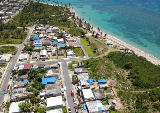 (AP Photo/Dennis M. Rivera, File). FILE - This June 18, 2018 file photo shows an aerial photo of the Viequez neighborhood, east of San Juan, Puerto Rico, where people were still living in damaged homes, protected by blue plastic tarps, nine months sinc... (AP Photo/Dennis M. Rivera, File). FILE - This June 18, 2018 file photo shows an aerial photo of the Viequez neighborhood, east of San Juan, Puerto Rico, where people were still living in damaged homes, protected by blue plastic tarps, nine months sinc...