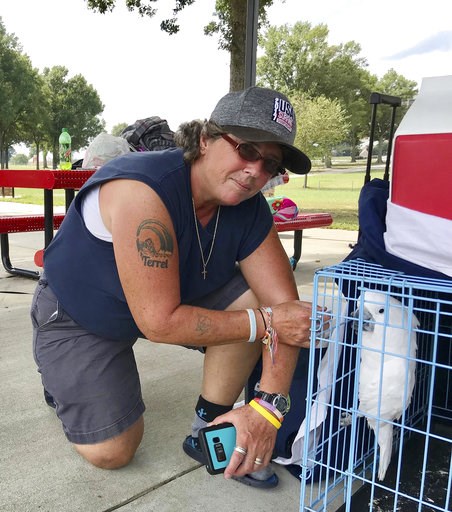 (AP Photo/Jeff Martin). CORRECTS NAME TO LISA, NOT MELODY - Lisa Rawson looks over the possessions she grabbed from her first-floor apartment in Myrtle Beach, S.C., which are now spread out at a campground at the Atlanta Motor Speedway, and her two dog... (AP Photo/Jeff Martin). CORRECTS NAME TO LISA, NOT MELODY - Lisa Rawson looks over the possessions she grabbed from her first-floor apartment in Myrtle Beach, S.C., which are now spread out at a campground at the Atlanta Motor Speedway, and her two dog...