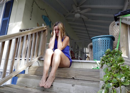 (AP Photo/Chuck Burton). Phoebe Tesh covers her face as she talks about packing to evacuate from Wrightsville Beach, N.C., Wednesday, Sept. 12, 2018 as Hurricane Florence threatens the coast. (AP Photo/Chuck Burton). Phoebe Tesh covers her face as she talks about packing to evacuate from Wrightsville Beach, N.C., Wednesday, Sept. 12, 2018 as Hurricane Florence threatens the coast.