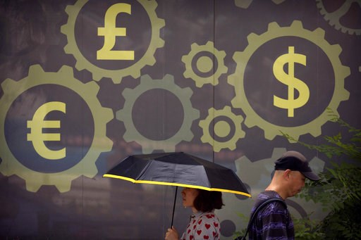 (AP Photo/Mark Schiefelbein, File). FILE - In this July 20, 2018 photo, people walk past a mural displaying world currency symbols on the outside of a bank in Beijing. Amid a worsening tariff battle, China is putting off accepting license applications ... (AP Photo/Mark Schiefelbein, File). FILE - In this July 20, 2018 photo, people walk past a mural displaying world currency symbols on the outside of a bank in Beijing. Amid a worsening tariff battle, China is putting off accepting license applications ...